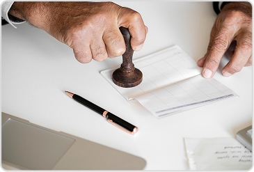 Official applying notary stamp on school transfer certificate