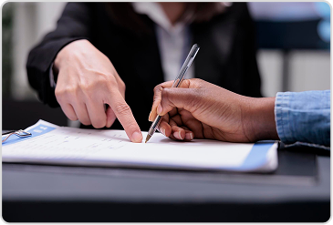 Close-up of hands signing school transfer certificate document